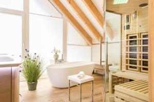 a bathroom with a white tub and a sink at Haus Meeresleuchten mit Sauna- und Erlebnisbadnutzung in Ostseebad Sellin +23 photos
