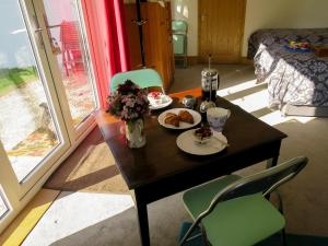a table with two plates of food and flowers on it at Hill View in Binegar