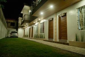 a house with a car parked outside of it at night at MAILZ HAVEN BEAUTIFL 3BR MODERN APRT NEAR SM DOOR-C in Davao City