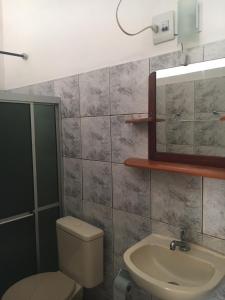 a bathroom with a toilet and a sink at Algodoal Bela Mar Pousada in Algodoal