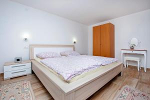 una camera con un grande letto e un armadio in legno di Keser Apartments a Rovigno (Rovinj)
