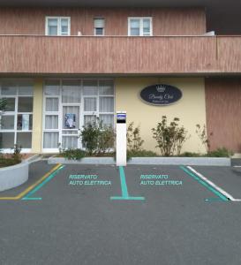 a parking lot in front of a hotel at Hotel Rex in Livorno