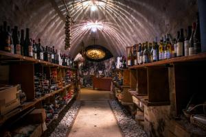 a room filled with lots of bottles of wine at Antico Furlo in Acqualagna