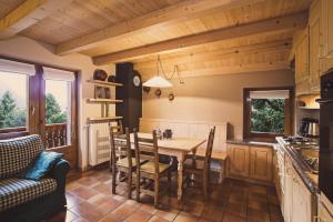 a kitchen with a table and chairs in a room at Chalet Terme Bormio in Bormio