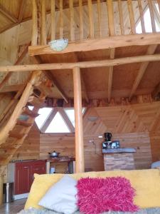 a bed in a room with a wooden ceiling at domoschiloe in Ancud