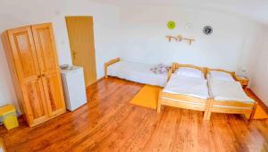 A bed or beds in a room at Penzión Gardoš
