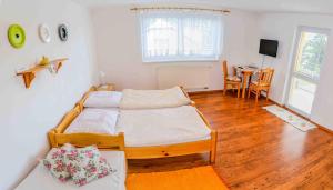 A bed or beds in a room at Penzión Gardoš