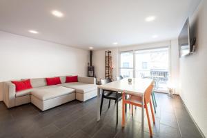 a living room with a couch and a table at Casa Mutta in Laax