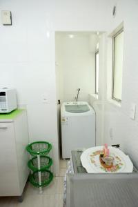 a small kitchen with a sink and a plate on a table at Apartamento 2 quartos in Laguna