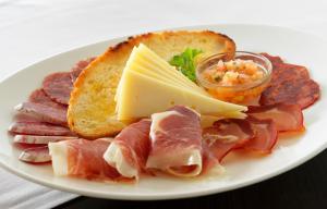 a plate of food with meats and cheese and toast at H10 Gran Tinerfe - Adults Only in Adeje