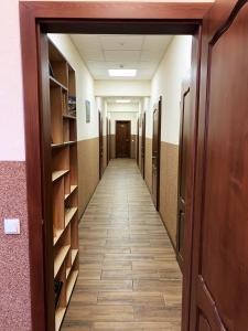 a corridor of a hallway with bookshelves and a hallway at Hostel Gulliver in Uzhhorod
