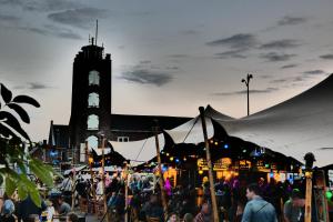 a crowd of people at a market in front of a clock tower at De Oude Brandweerkazerne 2 tot 4 persoons 2 kamer appartement in Kaatsheuvel