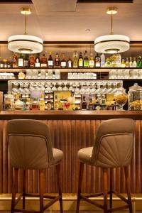 two chairs sitting at a bar in a restaurant at St-Alban Hotel & Spa in La Clusaz