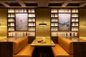 a restaurant with two benches and a table and books at St-Alban Hotel & Spa in La Clusaz