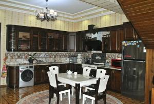 a kitchen with a table and chairs in it at Like Guest House in Samarkand