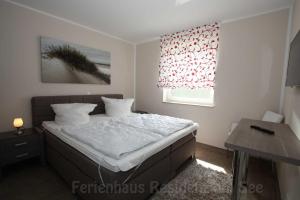 Postel nebo postele na pokoji v ubytování Ferienhaus Residenz am See + 27 fotografií