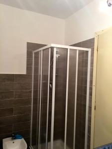 y baño con ducha y puerta de cristal. en Rio Piccolo Apartment, en Principina a Mare