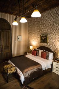 a bedroom with a large bed and two lights at kyrenia palace boutique hotel in Kyrenia