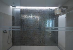 a bathroom with a shower with a tile wall at Hotel Alto Lido in Funchal