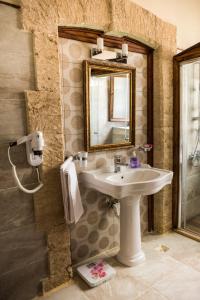 a bathroom with a sink and a mirror at kyrenia palace boutique hotel in Kyrenia
