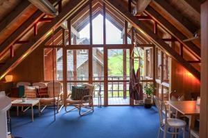 a room with tables and chairs and a large window at Haus am Wasserfall in Mellau