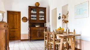 a kitchen with a wooden table and a wooden cabinet at Casa Casciu La collina sul mare in Costa Rei