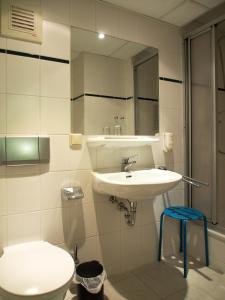 uma casa de banho com um lavatório, um WC e um espelho. em Pension Ottendorf-Okrilla em Ottendorf-Okrilla
