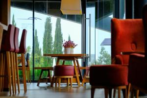 a table and chairs in a room with a large window at Herdade da Cortesia Hotel in Avis