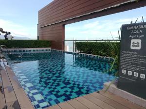 a swimming pool in front of a building at Mevin Woodsbury Home Butterworth Penang in Butterworth +36 photos
