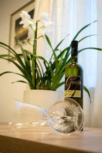 a bottle of wine and a glass on a table at Apartmani Val in Pula