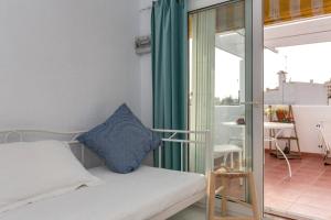 a small bedroom with a bed and a balcony at old town Charming retreat with sunny terrace in Marbella