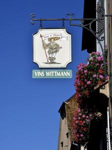 a sign for the wms withiniminant on a building at Le Grenier Des Arômes Au Domaine Wittmann in Mittelbergheim