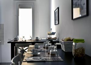 a dining room with a black table and chairs at Fellini in Rome