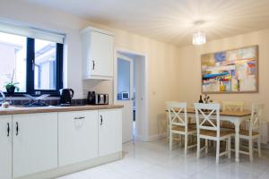 a kitchen and dining room with a table and chairs at New In Newcastle in Newcastle
