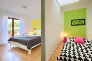 a bedroom with a bed and green walls at Apartment Lucca Peroj in Peroj