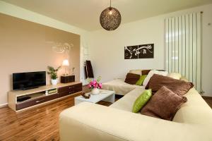 a living room with a white couch and a tv at Apartment Lucca Peroj in Peroj