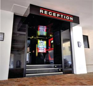 an entrance to a restaurant with a sign on the door at Check Inn Hotel in Cape Town