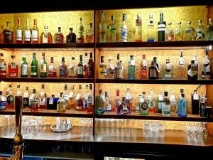 a shelf filled with lots of bottles of alcohol at Albright Hussey Manor in Shrewsbury