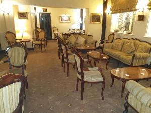 sala de estar con mesas, sofás y sillas en Albright Hussey Manor, en Shrewsbury