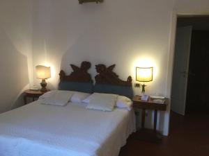 a bedroom with a large bed with two lamps at Agriturismo Alla Cedrara in Ferrara