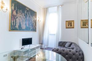 a living room with a chair and a glass table at Prinsi Apartments in Rome
