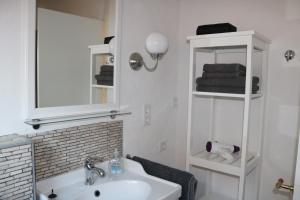 a bathroom with a sink and a mirror at Nordseeperle Husum in Husum +32 photos