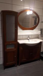 a bathroom with a sink and a mirror at Svinøya, hyggelig leilighet in Svolvær