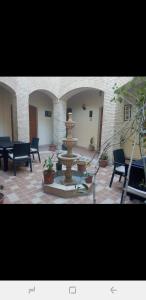 a fountain in the middle of a courtyard with chairs at Residence Tozeur Almadina in Tozeur +21 photos