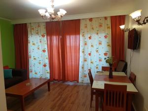 a living room with a table and a dining room at Apartment in Porto Sokhna Pyramids for Families in Ain Sokhna