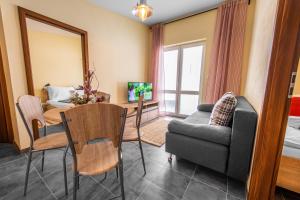 a living room with a table and a chair and a couch at Sojka Resort in Bešeňová