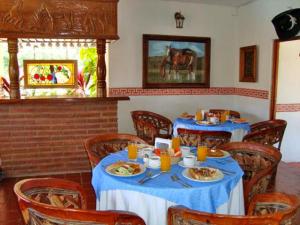 a dining room with two tables with plates of food at Canadian Resort Vallarta in Bucerías