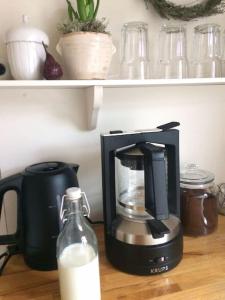 a coffee maker and a bottle of milk on a table at Ferienwohnung Alte Scheune in Egestorf