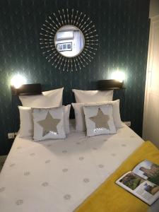 a bedroom with a bed with a mirror on the wall at Appartement Saint-Sauveur in Perpignan