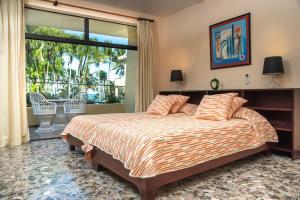 a bedroom with a bed with a view of a patio at Cabarete Palm Beach Condos in Cabarete +80 photos